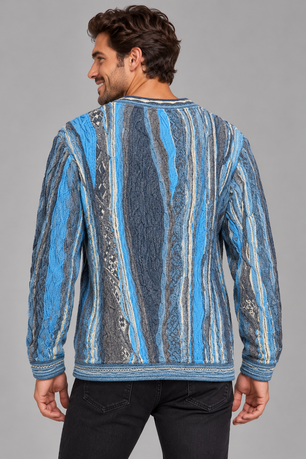A man wearing a blue and gray vertically patterned knit sweater, shown from the back against a solid gray studio background.